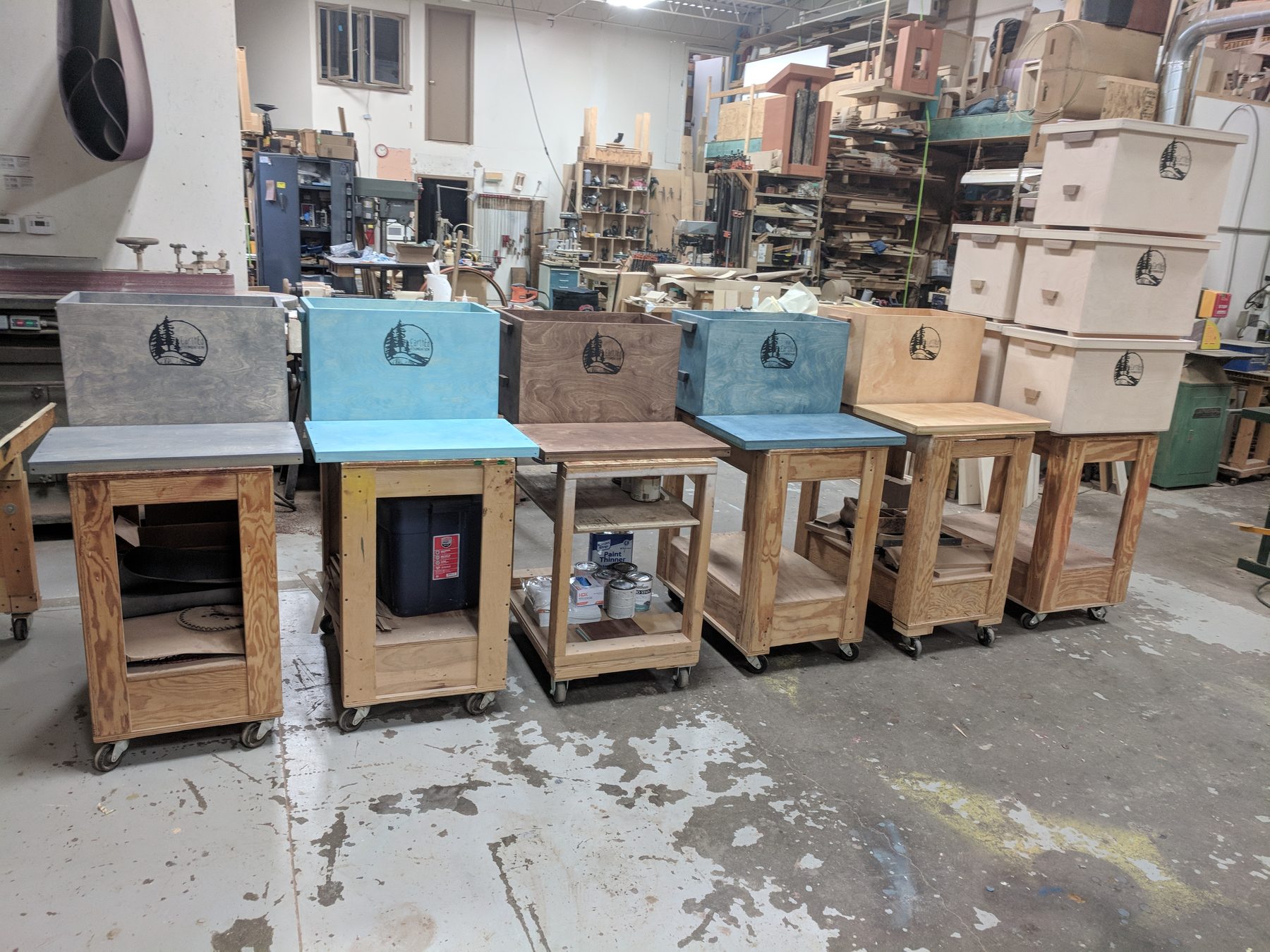 A row of freshly stained boxes on shop carts